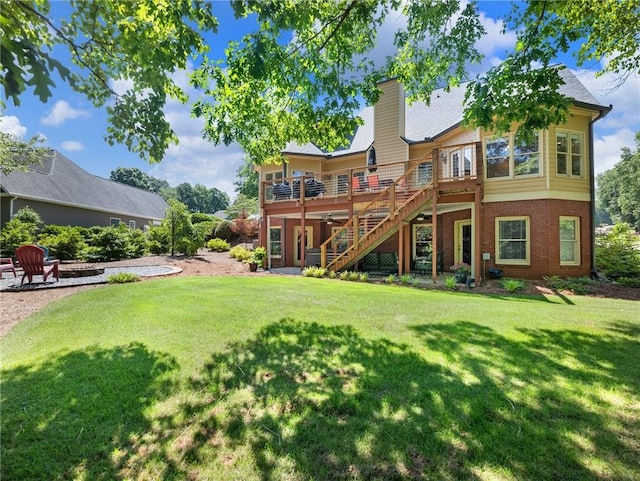 4523 Warwick Glen Pl, Flowery Branch, GA 30542 - rear view of property featuring stairs, a deck, a yard, brick siding, and a chimney