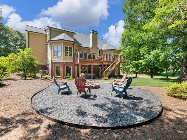 4523 Warwick Glen Pl, Flowery Branch, GA 30542 - back of house with stairs, a deck, an outdoor fire pit, a chimney, and a patio area