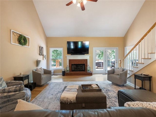 4523 Warwick Glen Pl, Flowery Branch, GA 30542 - living room featuring high vaulted ceiling, healthy amount of natural light, ceiling fan, wood finished floors, and stairs