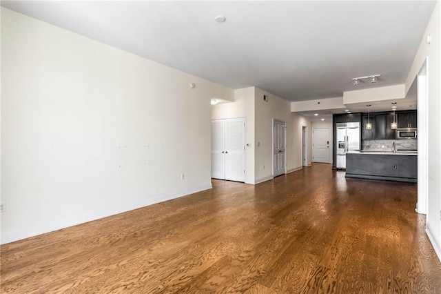 unfurnished living room with dark hardwood / wood-style flooring