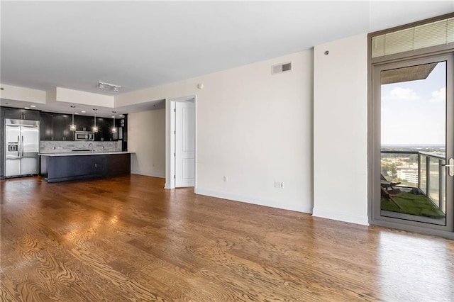 unfurnished living room with dark hardwood / wood-style floors