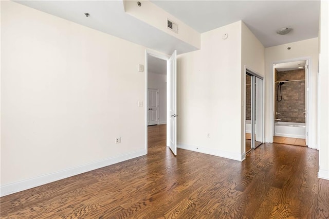 unfurnished room featuring dark wood-type flooring