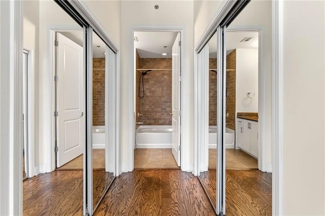 corridor with wood-type flooring