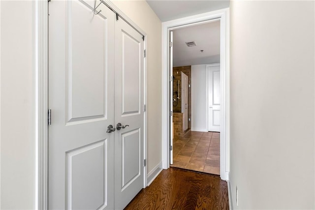 corridor featuring dark wood-type flooring