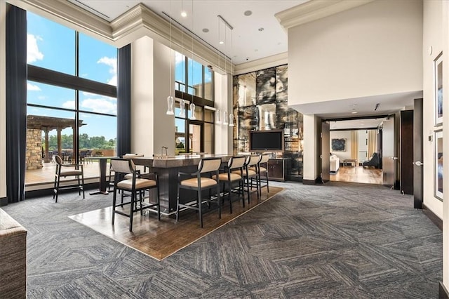 carpeted dining room featuring a high ceiling