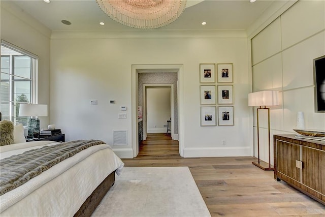 bedroom with crown molding, visible vents, baseboards, recessed lighting, and light wood finished floors