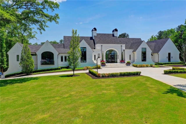 view of front of home featuring a front lawn and a chimney