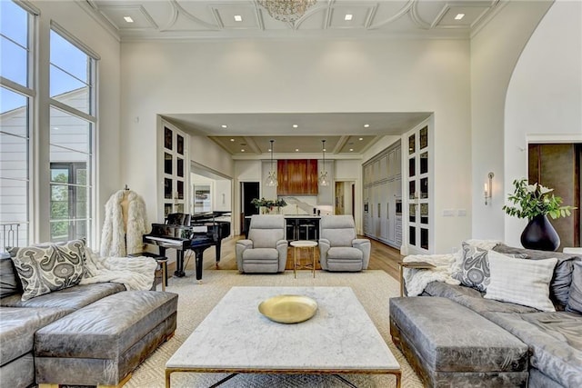 living area with recessed lighting and ornamental molding