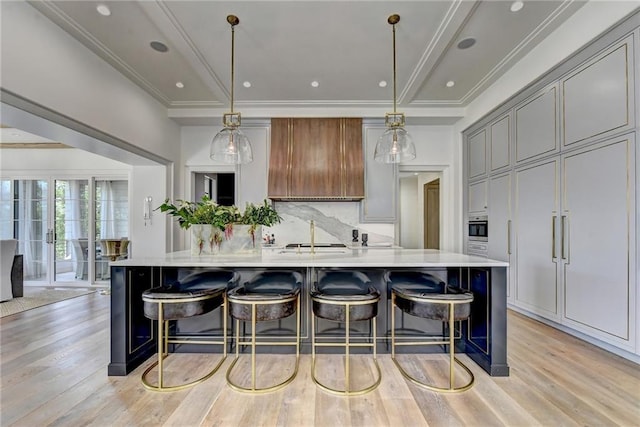 kitchen with light wood-style floors, light countertops, and a breakfast bar