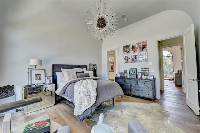 bedroom featuring a notable chandelier and hardwood / wood-style floors