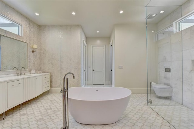 bathroom featuring recessed lighting, tile patterned floors, a soaking tub, and vanity