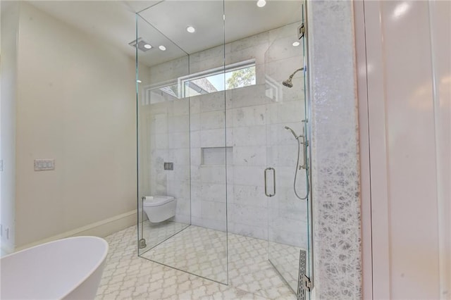 bathroom featuring baseboards, a stall shower, a freestanding bath, and recessed lighting