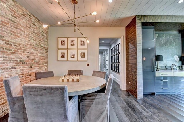 dining room with wood ceiling, recessed lighting, brick wall, and dark wood-type flooring