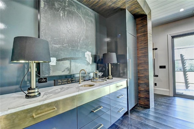 interior space featuring baseboards, dark wood-type flooring, wooden ceiling, a sink, and backsplash