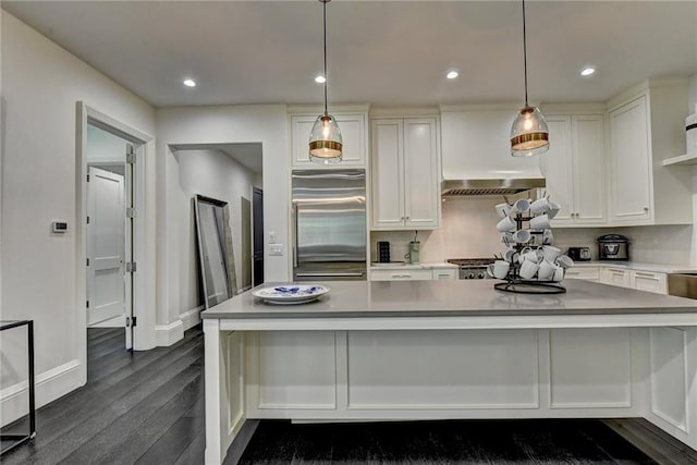 kitchen with dark wood-style flooring, white cabinetry, a large island, baseboards, and built in refrigerator