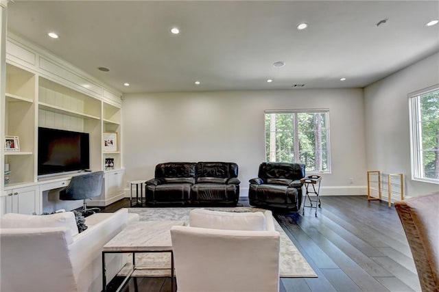 living area featuring recessed lighting, baseboards, dark wood finished floors, and built in shelves