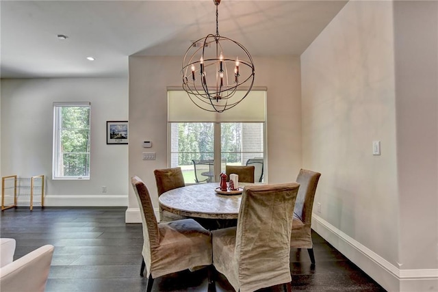 dining room with recessed lighting, baseboards, dark wood-type flooring, and a notable chandelier