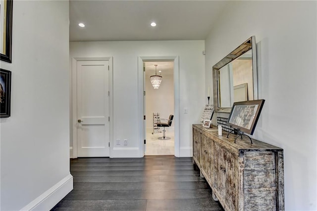 corridor featuring recessed lighting, baseboards, and dark wood-style floors