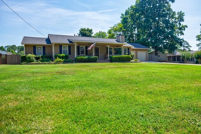 ranch-style house featuring covered porch, a garage, and a front lawn