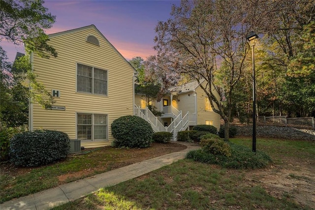 property exterior at dusk with a yard