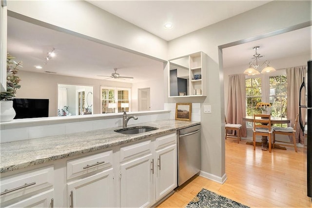 kitchen featuring light stone countertops, white cabinets, ceiling fan with notable chandelier, sink, and dishwasher