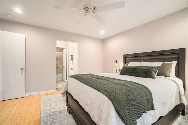 bedroom featuring ceiling fan, wood-type flooring, and ensuite bath