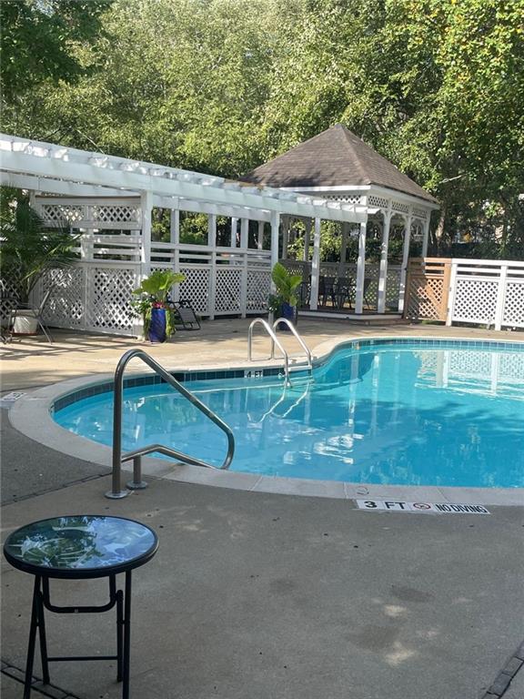 view of swimming pool with a patio area