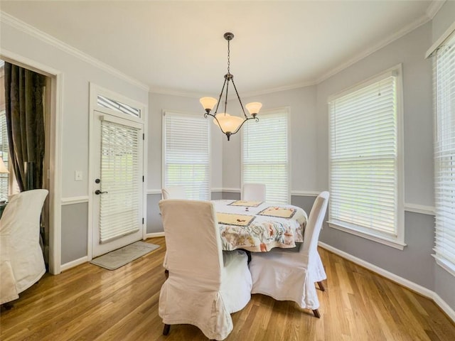710 Bentgrass Ct, Dacula, GA 30019 - dining area featuring wood finished floors, crown molding, and a chandelier