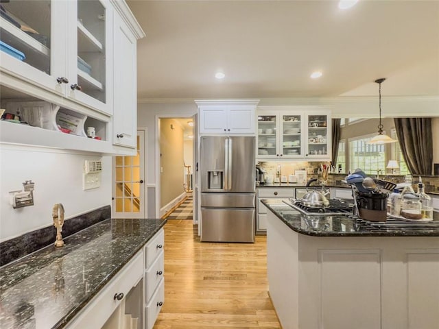 710 Bentgrass Ct, Dacula, GA 30019 - kitchen with appliances with stainless steel finishes, crown molding, light wood-style flooring, white cabinetry, and hanging light fixtures