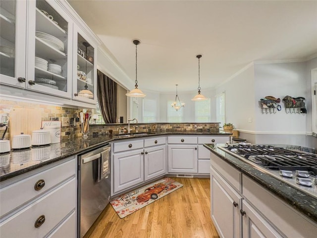 710 Bentgrass Ct, Dacula, GA 30019 - kitchen with appliances with stainless steel finishes, crown molding, light wood-type flooring, decorative backsplash, and pendant lighting