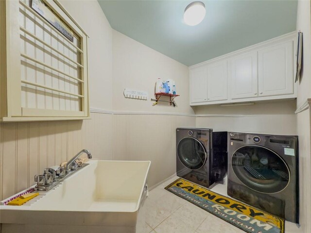 710 Bentgrass Ct, Dacula, GA 30019 - laundry area with washing machine and dryer, cabinet space, wainscoting, and tile patterned flooring