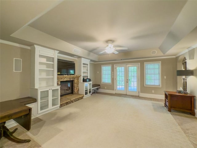 710 Bentgrass Ct, Dacula, GA 30019 - unfurnished living room featuring light carpet, a ceiling fan, french doors, a tray ceiling, and crown molding