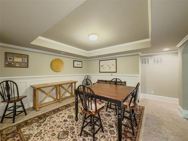 710 Bentgrass Ct, Dacula, GA 30019 - dining space with a tray ceiling, crown molding, and wainscoting