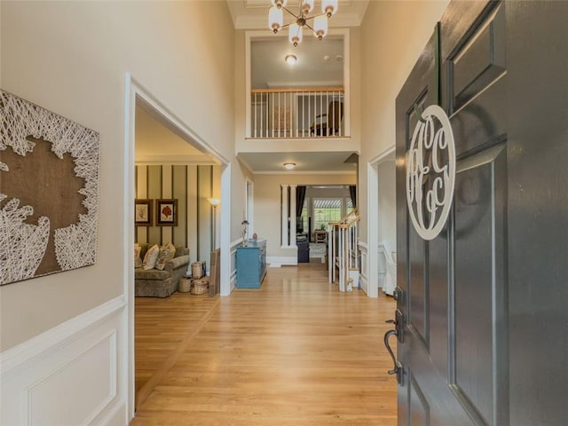 710 Bentgrass Ct, Dacula, GA 30019 - foyer with a high ceiling, ornamental molding, light wood-type flooring, and a chandelier