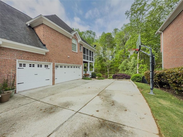 710 Bentgrass Ct, Dacula, GA 30019 - view of property exterior with driveway, brick siding, roof with shingles, and an attached garage