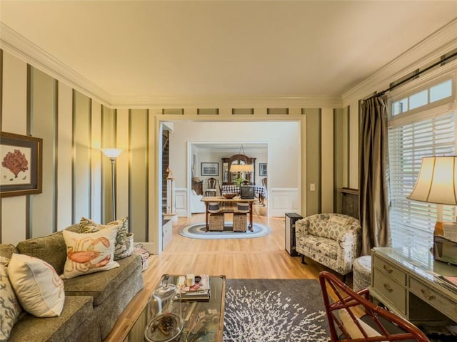 710 Bentgrass Ct, Dacula, GA 30019 - living room featuring a decorative wall, wood finished floors, ornamental molding, and wainscoting