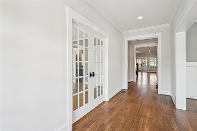 corridor featuring dark wood-style floors, visible vents, french doors, and crown molding