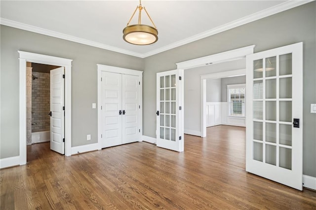 interior space featuring ornamental molding, french doors, baseboards, and wood finished floors