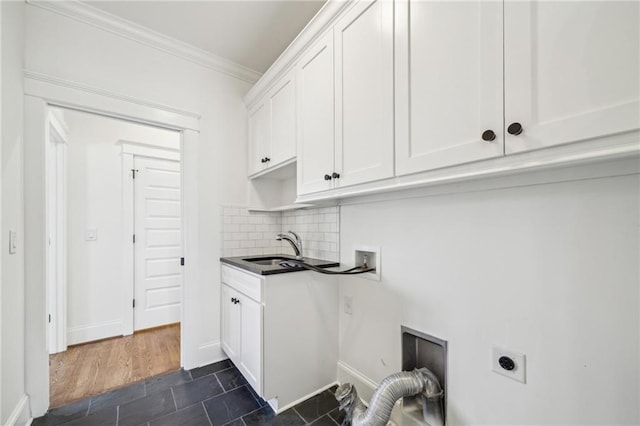 washroom featuring hookup for a washing machine, hookup for an electric dryer, cabinet space, ornamental molding, and a sink