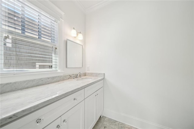 bathroom with baseboards, ornamental molding, and vanity