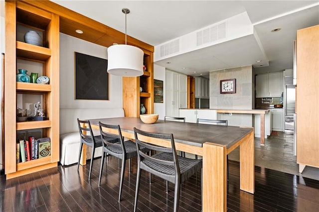 145 15th St NE Unit 435, Atlanta, GA 30309 - dining space featuring dark wood-style flooring and built in shelves