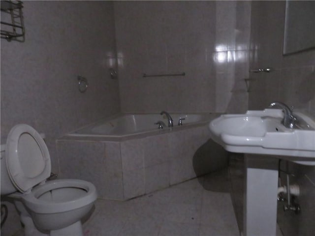 2447 Omaha Rd SW, Atlanta, GA 30331 - bathroom with toilet, tiled tub, tile patterned floors, and a sink