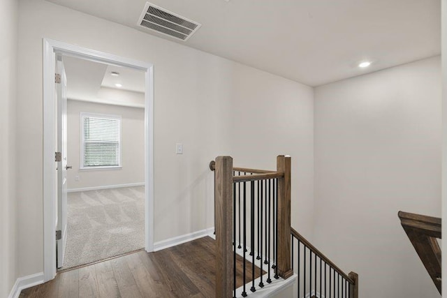 hallway with dark hardwood / wood-style floors