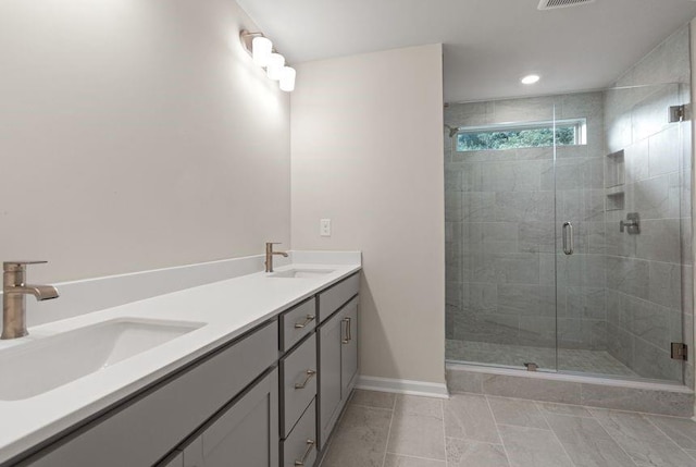 bathroom featuring vanity, walk in shower, and tile patterned flooring