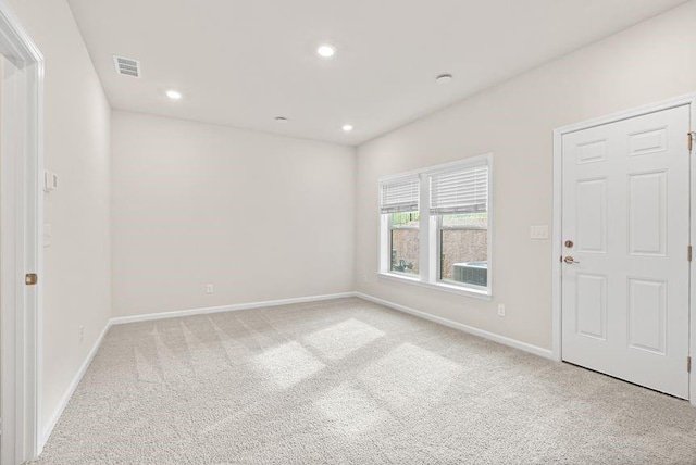 spare room with light colored carpet