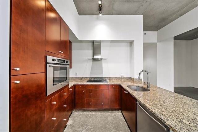 kitchen featuring sink, kitchen peninsula, stainless steel appliances, light stone countertops, and wall chimney range hood