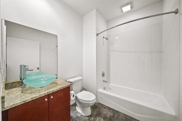 full bathroom featuring tiled shower / bath, vanity, and toilet