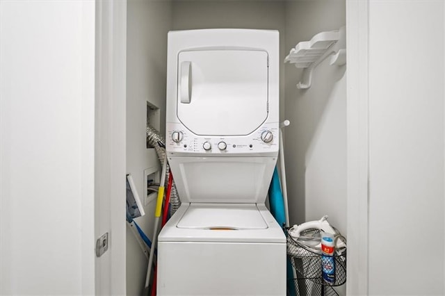 laundry area with stacked washing maching and dryer