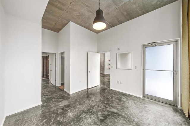 unfurnished bedroom with a towering ceiling