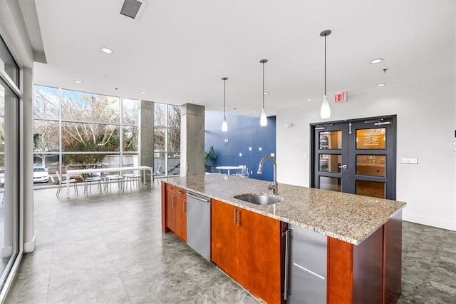 kitchen with dishwasher, a kitchen island with sink, sink, and decorative light fixtures